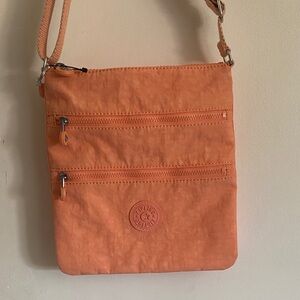 Kipling Coral Orange Round Logo Crossbody